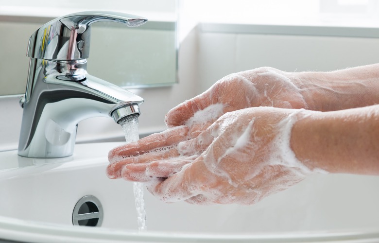 Person Washing Hands With Soap and Water